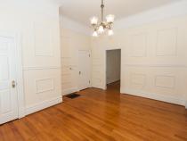 room with hanging lamp and doorway