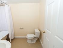 bathroom with tub and toilet