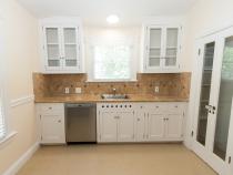 kitchen with glass cabinets above it